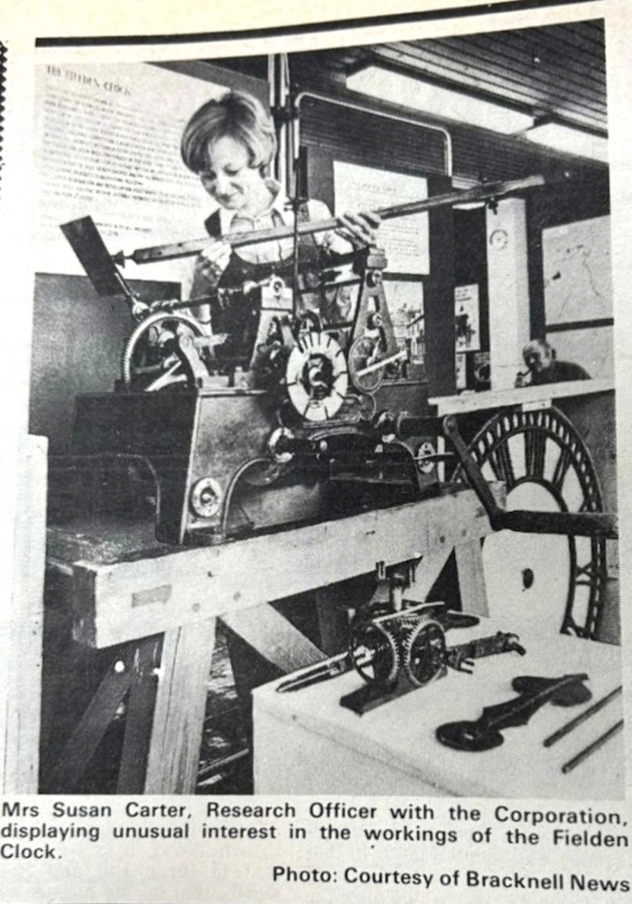 A woman holds onto a part of the Fielden Clock, Bracknell News 1977