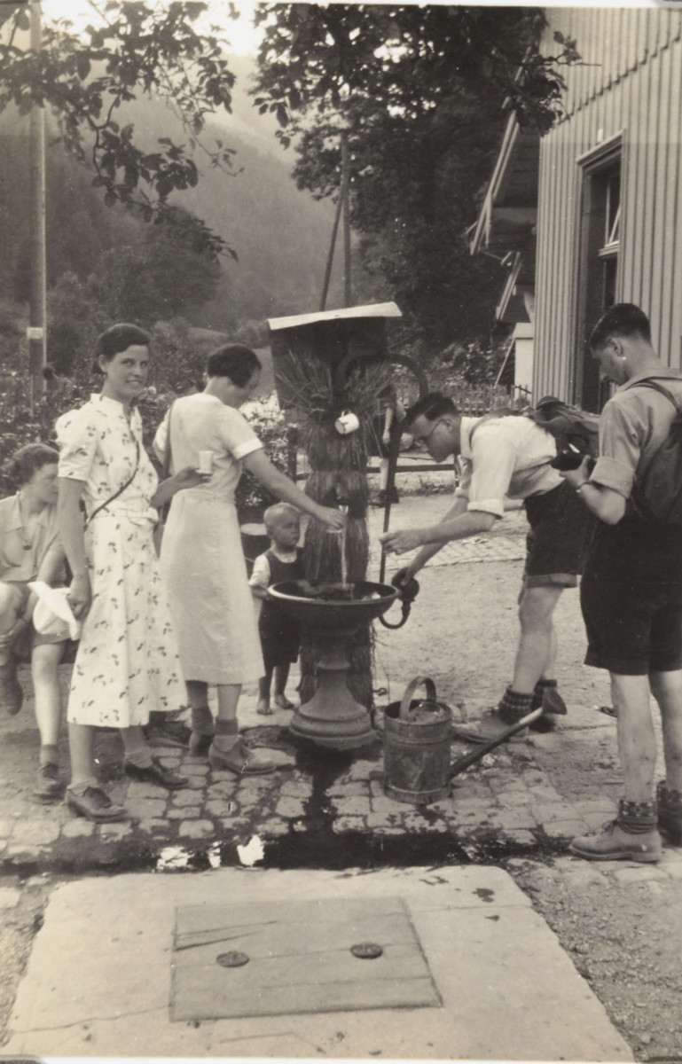 walkers at a drinking fountain in Germany, 1937 ref. D/EX2861/1