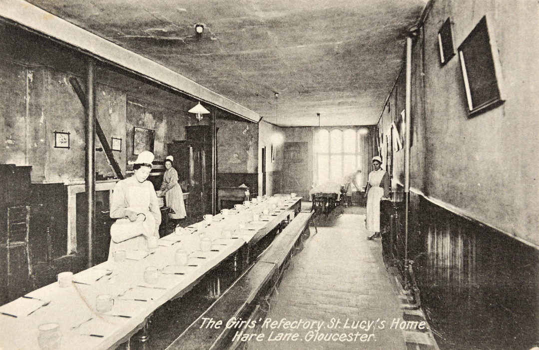 Refectory with long table and a lady pouring drinks ref. D/EX1675/12/6/3