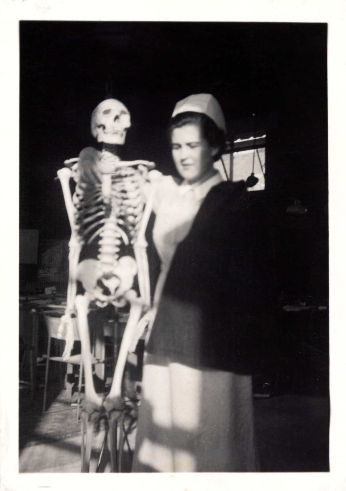 A woman nurse holds a medical skeleton ref. D?EX2871/1/14