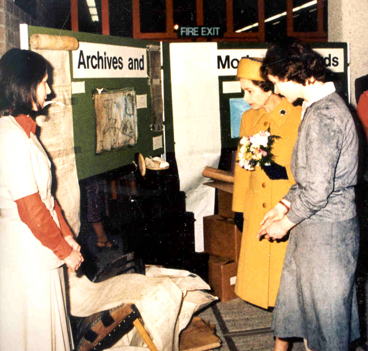 Amanda Arrowsmith County Archivist at the RBA 1979 to 1982 standing with Her Majesty Queen Elizabeth II at the opening of Shire Hall Reading in 1981. Another woman stands facing them.